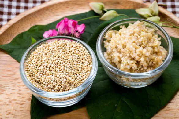 A bowl of cooked quinoa with fresh vegetables and herbs, highlighting its fluffy texture